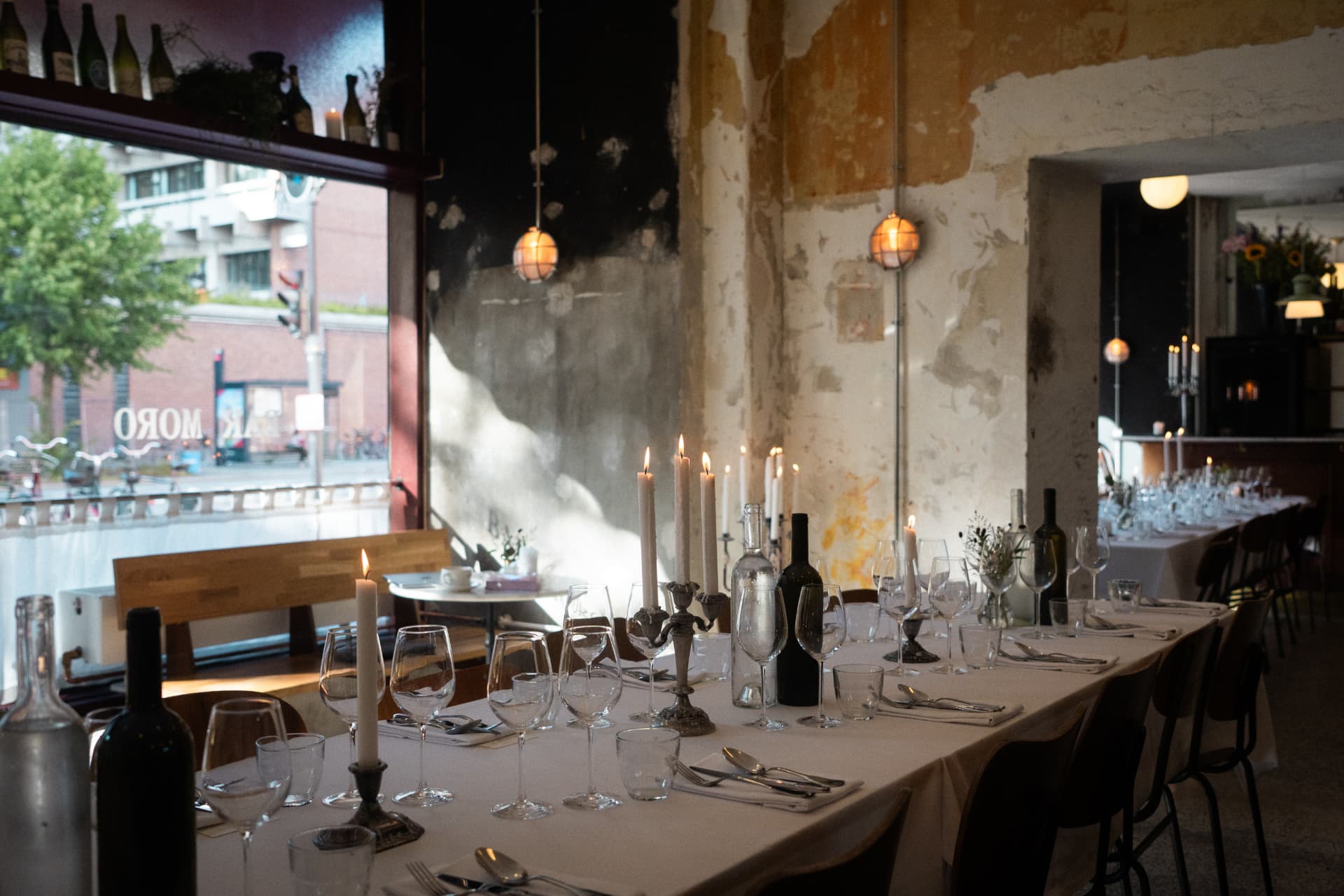Long table set with candles before a merchant roundtable dinner